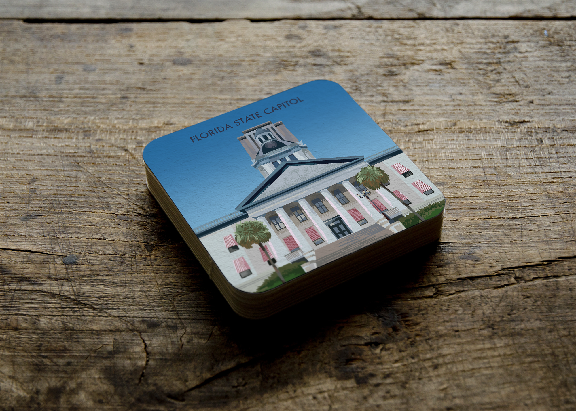 An illustration of the Florida capitol on a coaster